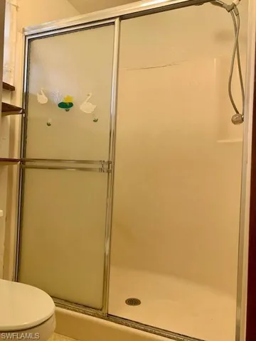 Bathroom featuring walk in shower and toilet