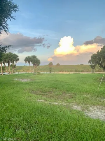 Yard at dusk featuring a rural view