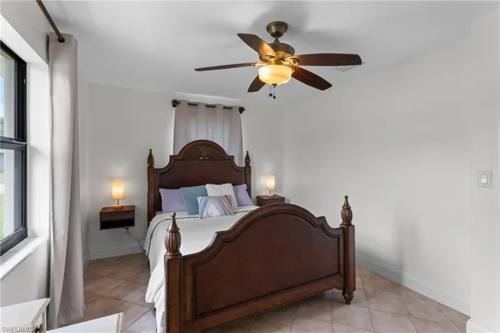 Tiled bedroom with ceiling fan