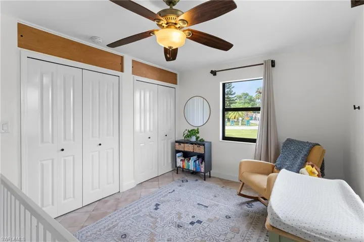 Sitting room featuring ceiling fan and light tile patterned floors