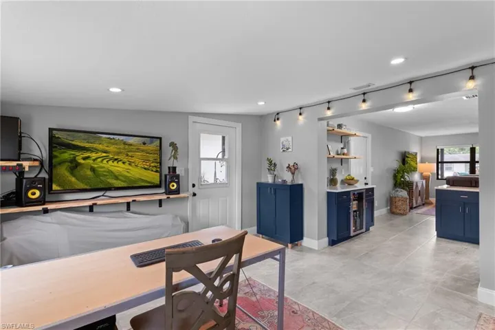 Dining room featuring vaulted ceiling and rail lighting
