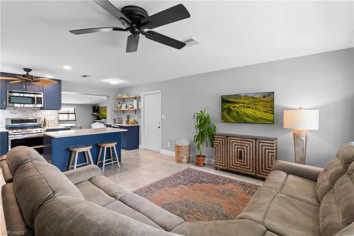 Tiled living room featuring ceiling fan