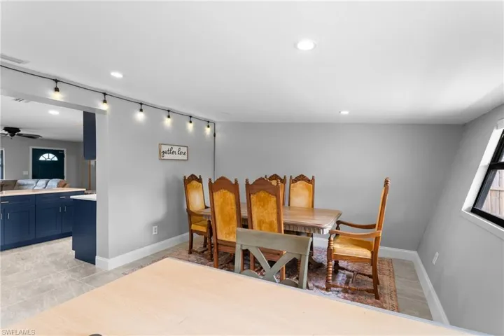 Dining area with light wood-type flooring and ceiling fan