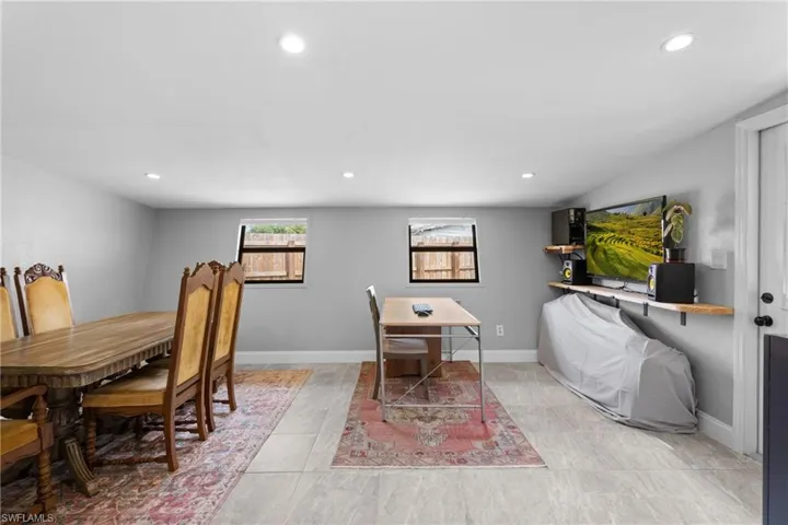 Dining area with light tile patterned flooring