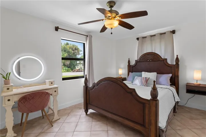 Tiled bedroom with ceiling fan