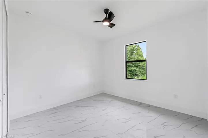 Guest bedroom featuring ceiling fan