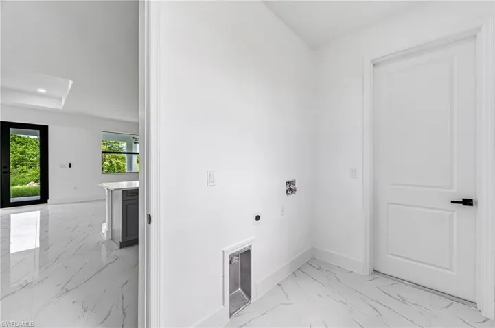 Washroom featuring hookup for a washing machine and hookup for an electric dryer