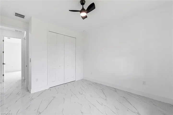 Guest bedroom with a closet and ceiling fan
