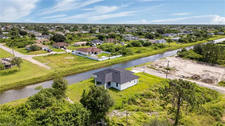 Birds eye view of property with a water view