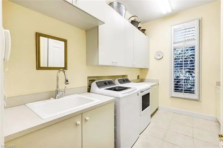 Large Laundry Room with plenty of storage cabinets