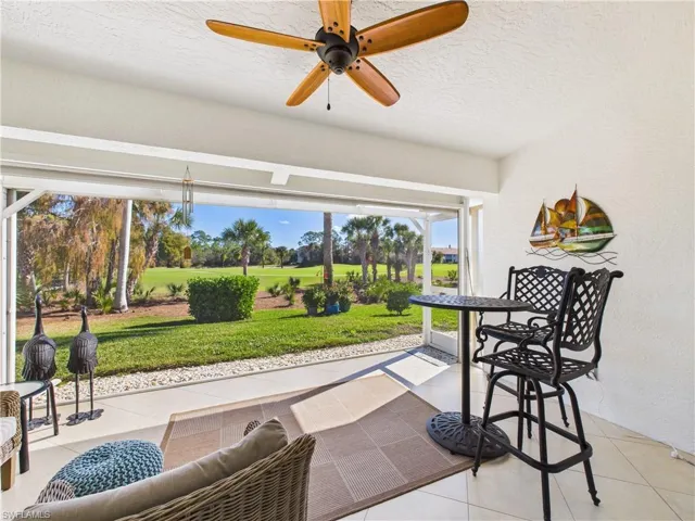 View of patio featuring ceiling fan and view of golf course