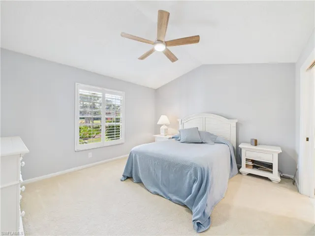 Bedroom with carpet flooring, lofted ceiling, and a ceiling fan