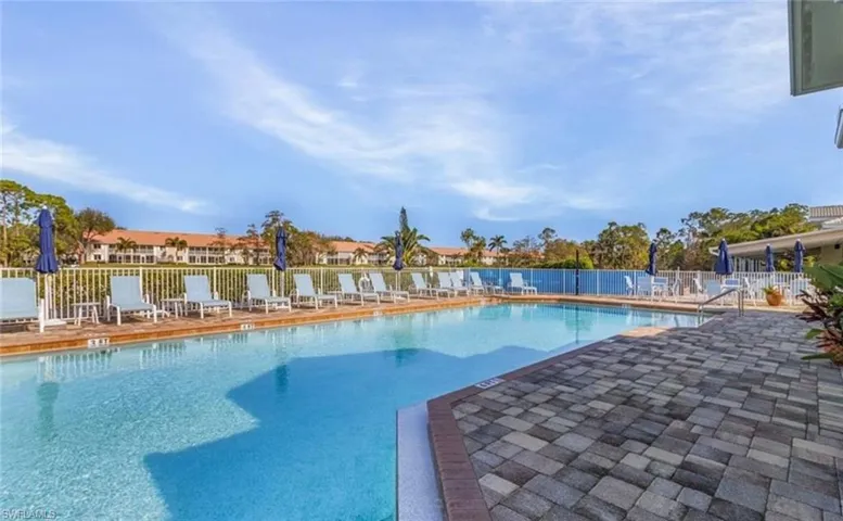 Community pool with a patio