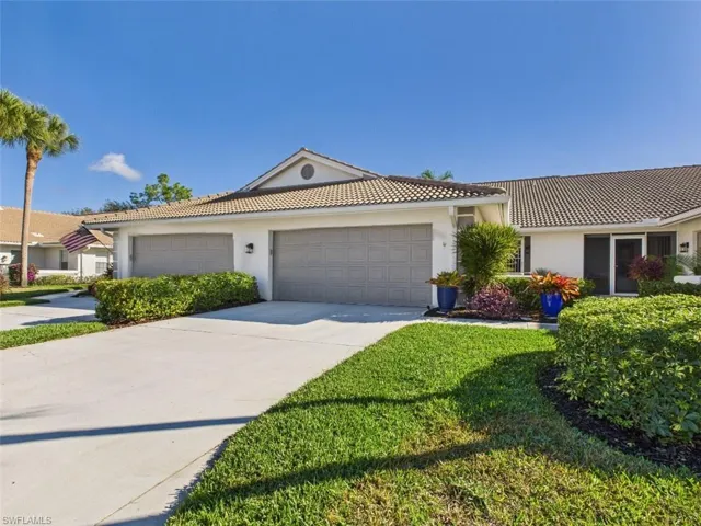 Ranch-style home with stucco siding, concrete driveway, a garage, and a tiled roof
