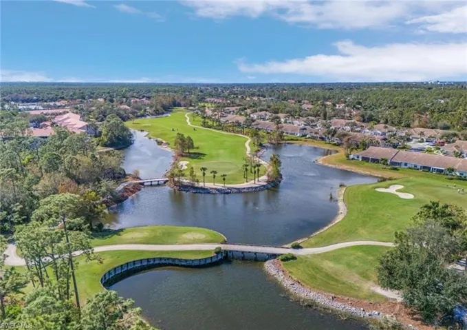 Aerial overview of property's location with a golf course and nearby suburban area