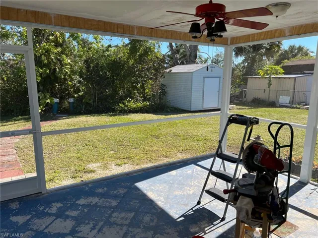 View of yard with a patio area, ceiling fan, and a shed