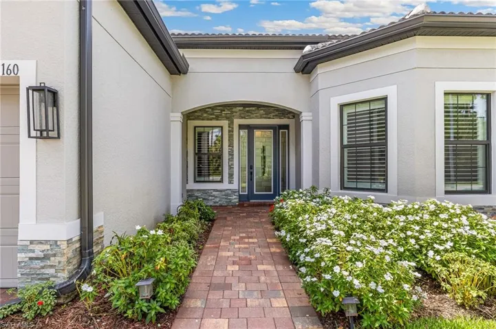 Custom Stonework, Upgraded Front Door with Sidelights, Storm Screen for Front Entry Protection