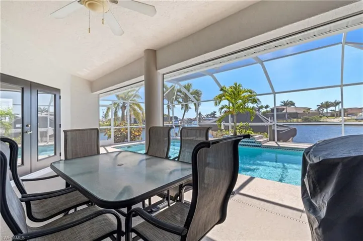 Lanai looking out at pool from under truss dining area