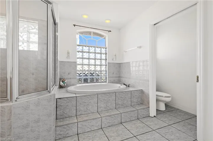 Walk in shower, soaker tub and private toilet in primary bathroom
