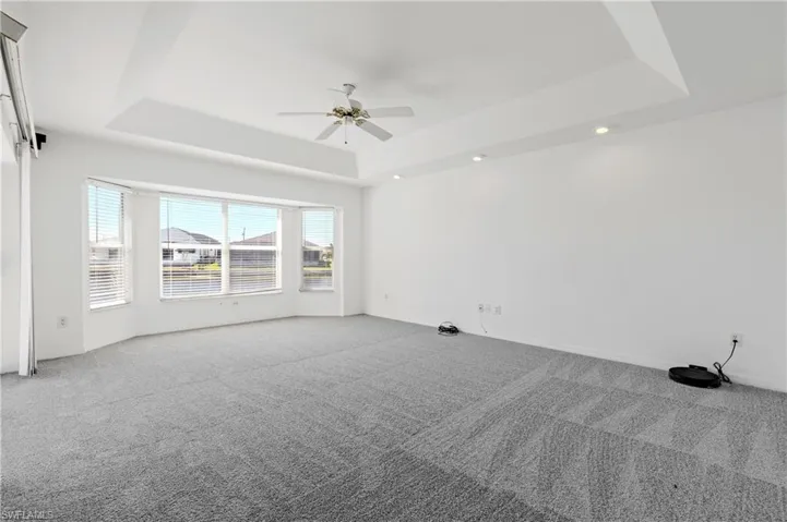 Bright and airy family room with sliders opening to pool are and screened in lanai