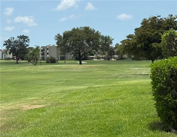 Surrounding community featuring a lawn and golf course