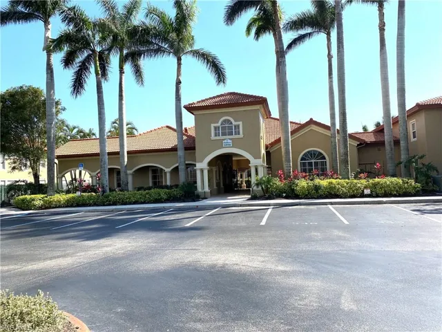 View of property featuring uncovered parking