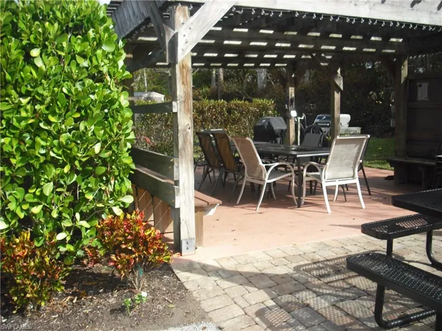 View of patio with a grill and a pergola