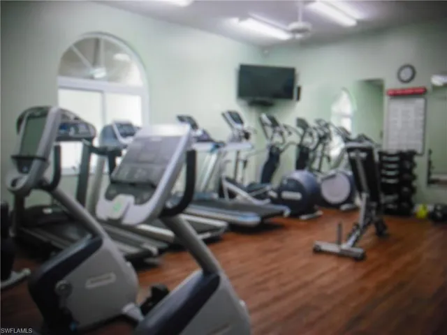 Workout area featuring wood-type flooring