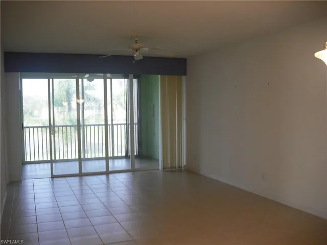 Tiled spare room with ceiling fan