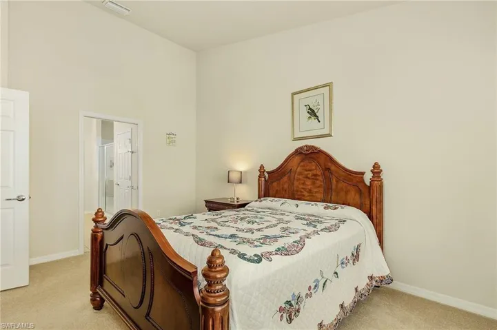 Bedroom featuring light colored carpet