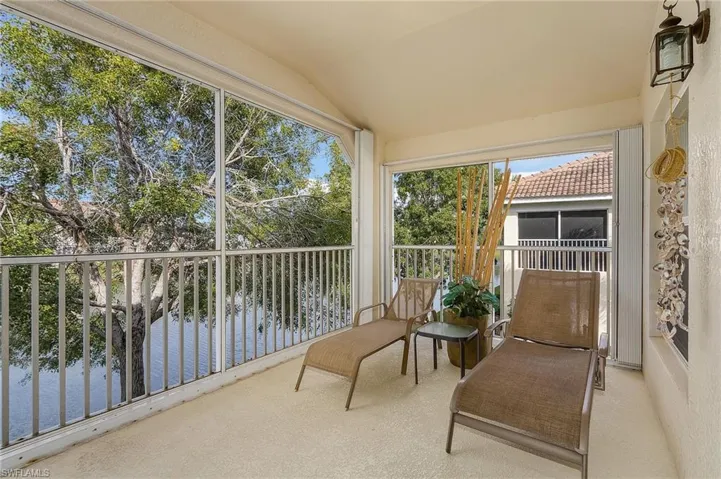 Sunroom featuring a water view and vaulted ceiling