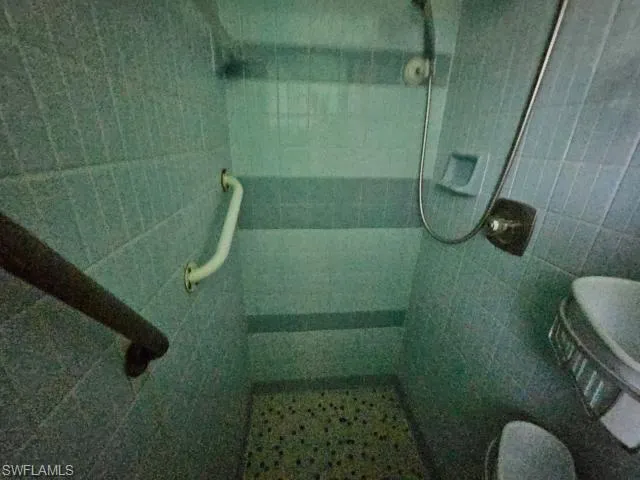 Bathroom featuring tile walls