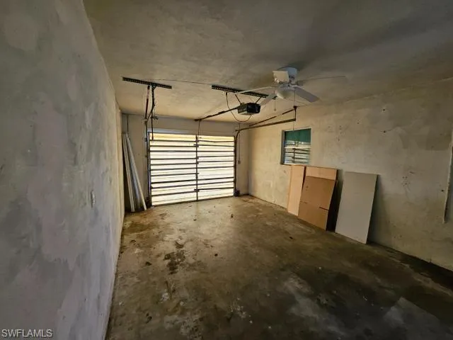 Garage with a garage door opener and ceiling fan