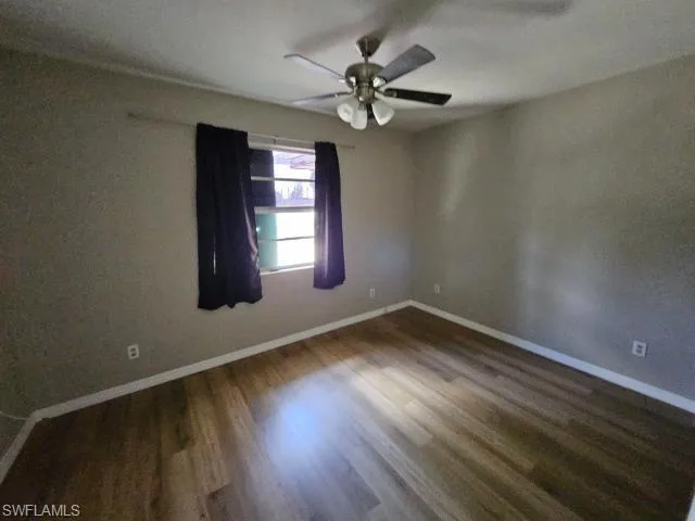 Spare room featuring ceiling fan and hardwood / wood-style floors