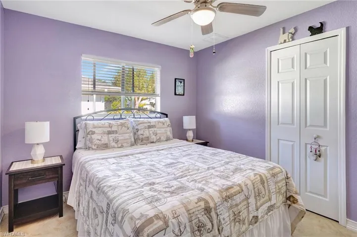 Bedroom featuring ceiling fan, light tile patterned floors, and a closet