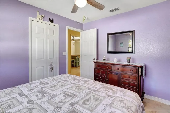 Bedroom featuring ceiling fan and a closet