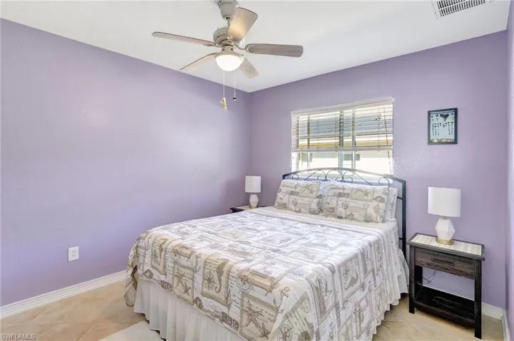 Tiled bedroom with ceiling fan