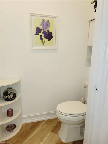 Bathroom featuring hardwood / wood-style floors and toilet
