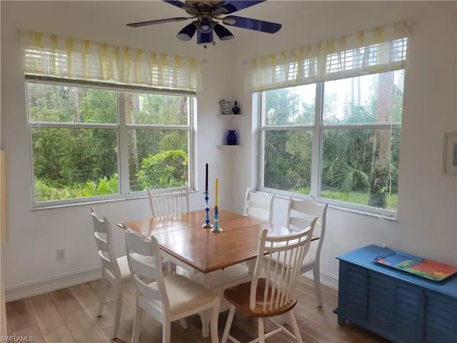 Dining area featuring ceiling fan, light hardwood / wood-style flooring, and a healthy amount of sunlight