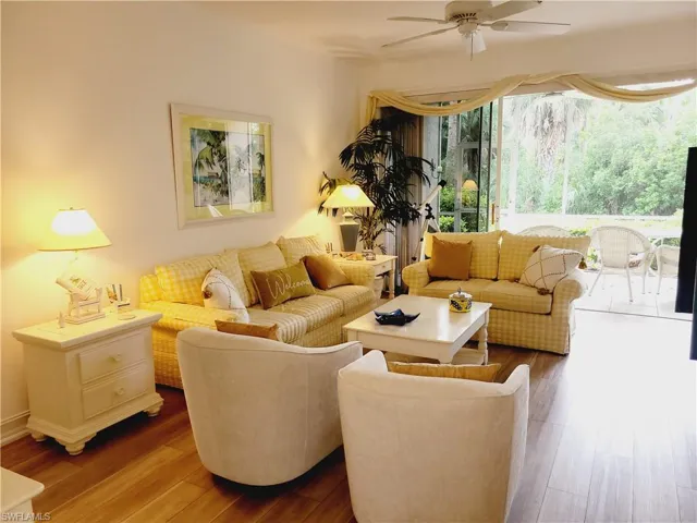 Living room with hardwood / wood-style flooring and ceiling fan