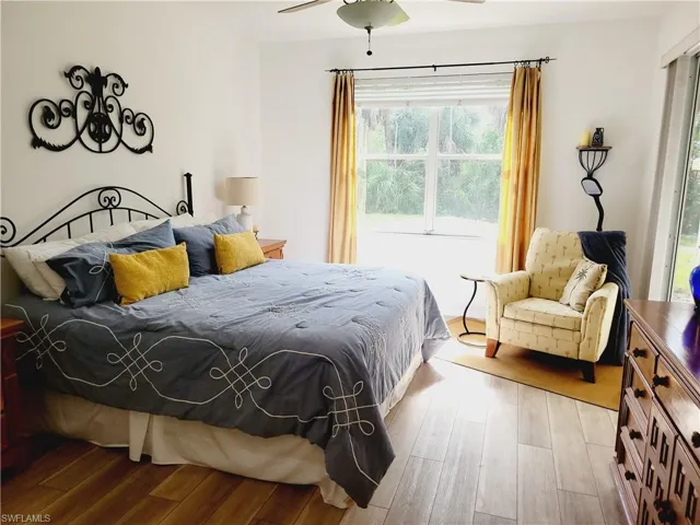 Bedroom with hardwood / wood-style flooring and ceiling fan