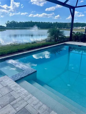 View of pool with a water view