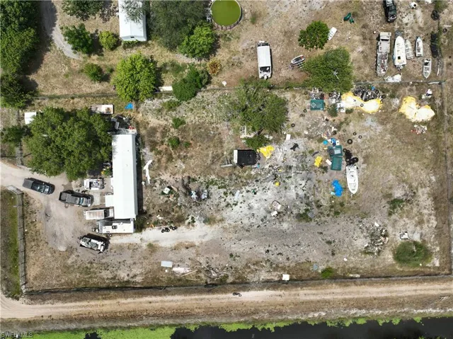 Expansive property featuring multiple structures and vehicles