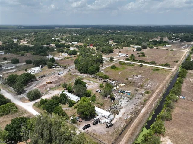 Expansive rural landscape featuring scattered residences and abundant mature trees