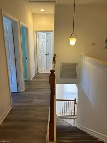 Hallway with baseboards and dark wood-style floors
