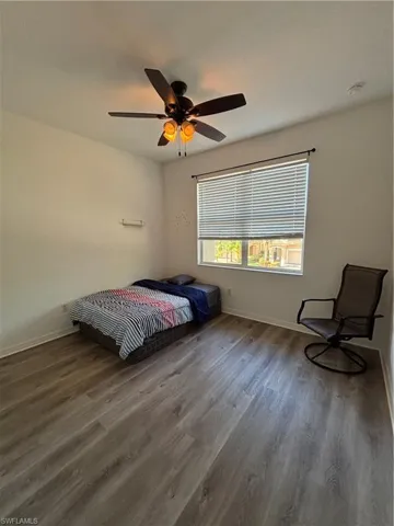 Bedroom with wood finished floors and ceiling fan