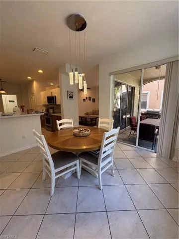 Dining space featuring light tile patterned floors