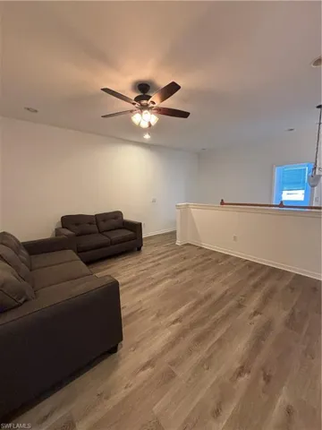 Living area featuring wood finished floors and baseboards