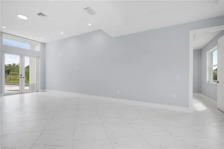 Unfurnished room featuring french doors and a healthy amount of sunlight
