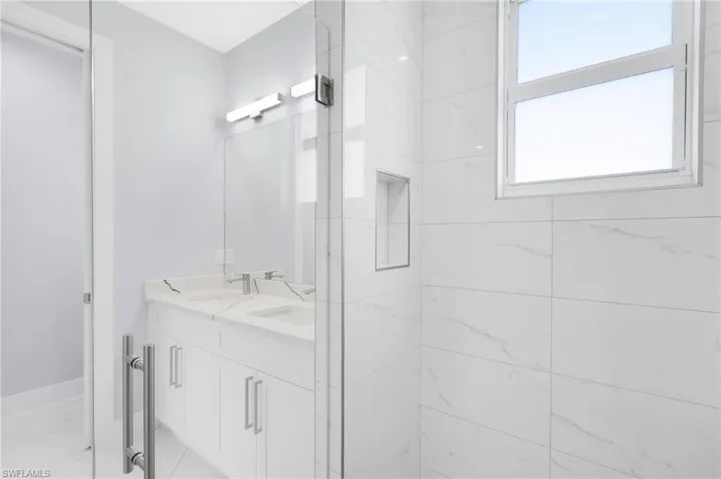 Bathroom with vanity and an enclosed shower